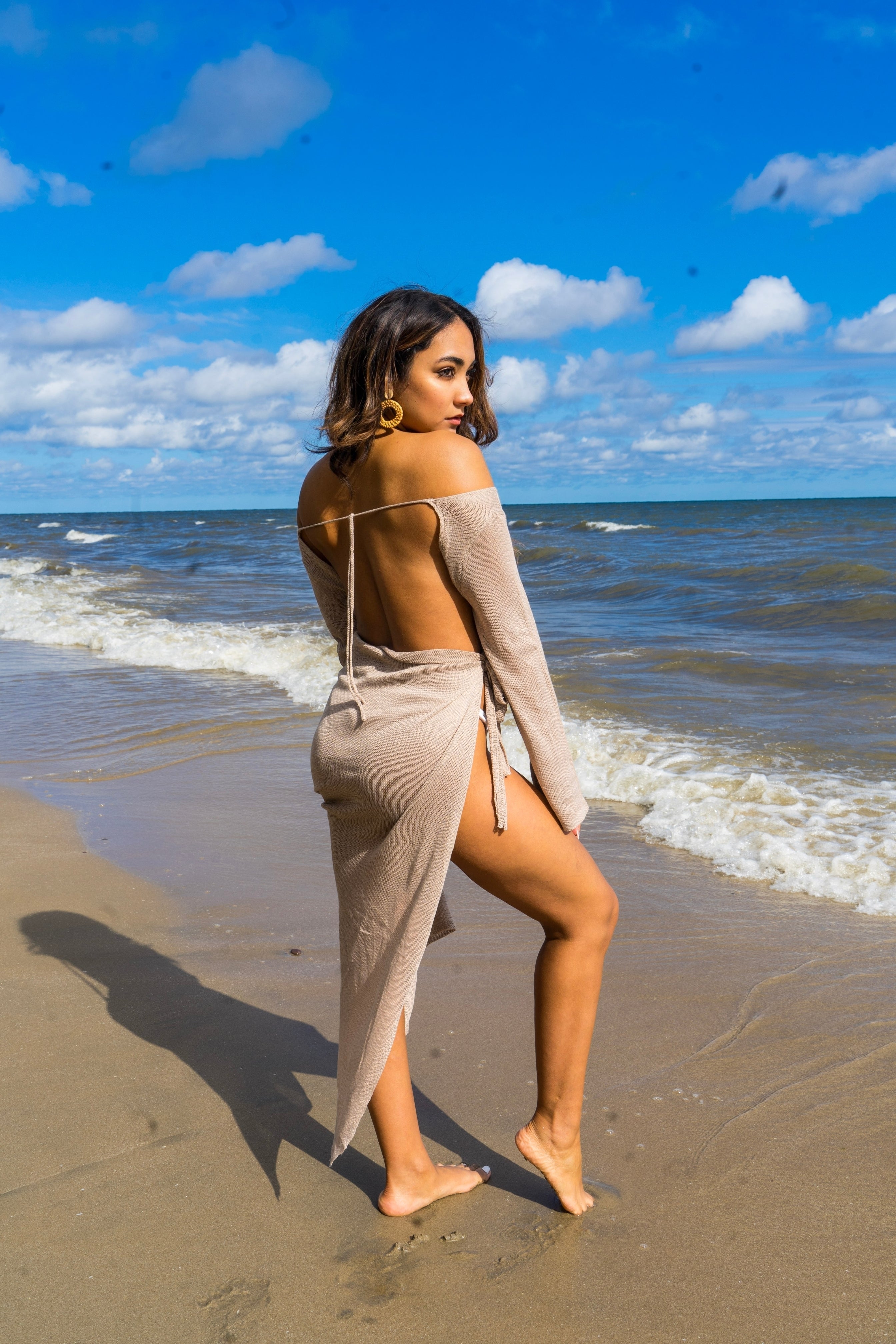 Beige beach cover-up made of 100% polyester with long sleeves. This cover-up open at the back with ties at the upper back and at the waist. This beautiful Cover Up has a leg opening that makes it look attractive.