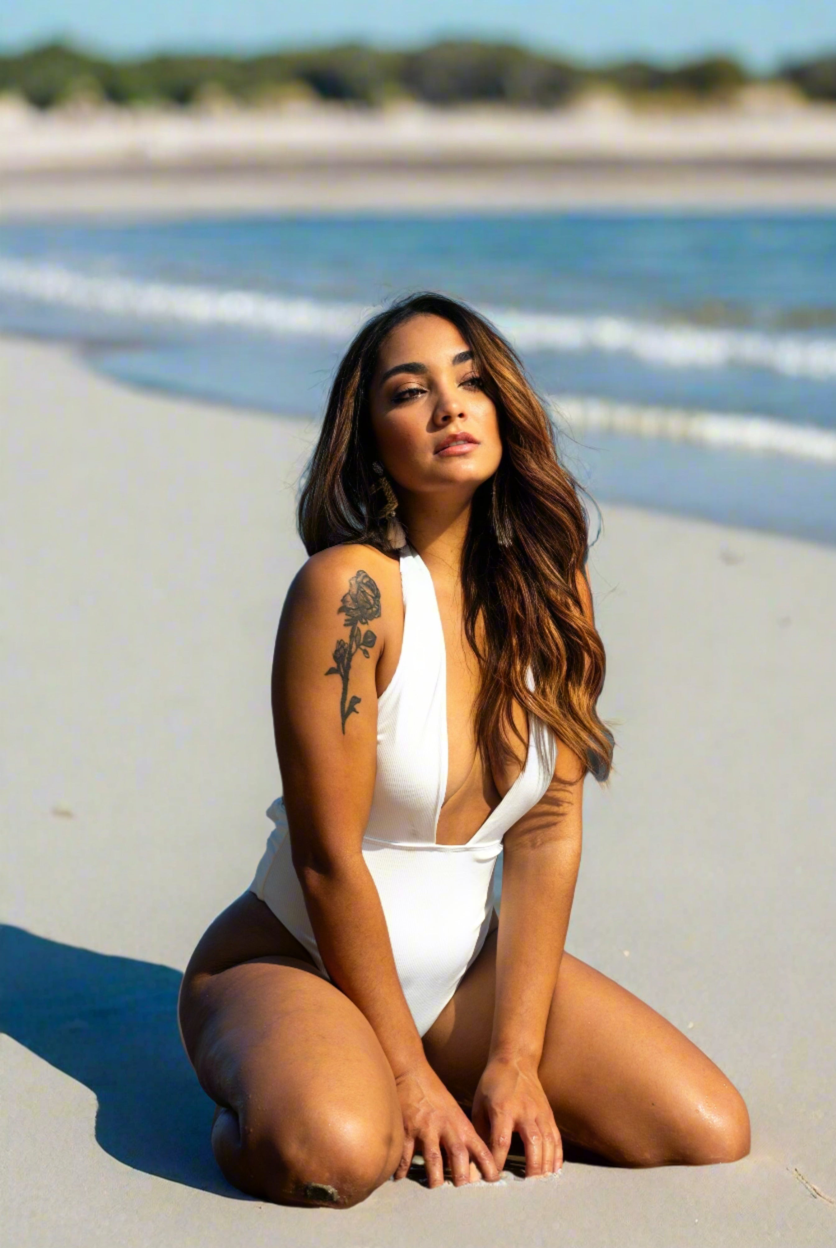 This white swimsuit is made of 82% Polyamide, 18% Elastane. This swimsuit has a V design on the front and ties at the neck. It is open at the back that make it look more atractive, and has straps that can be tied in front or back with a bow.